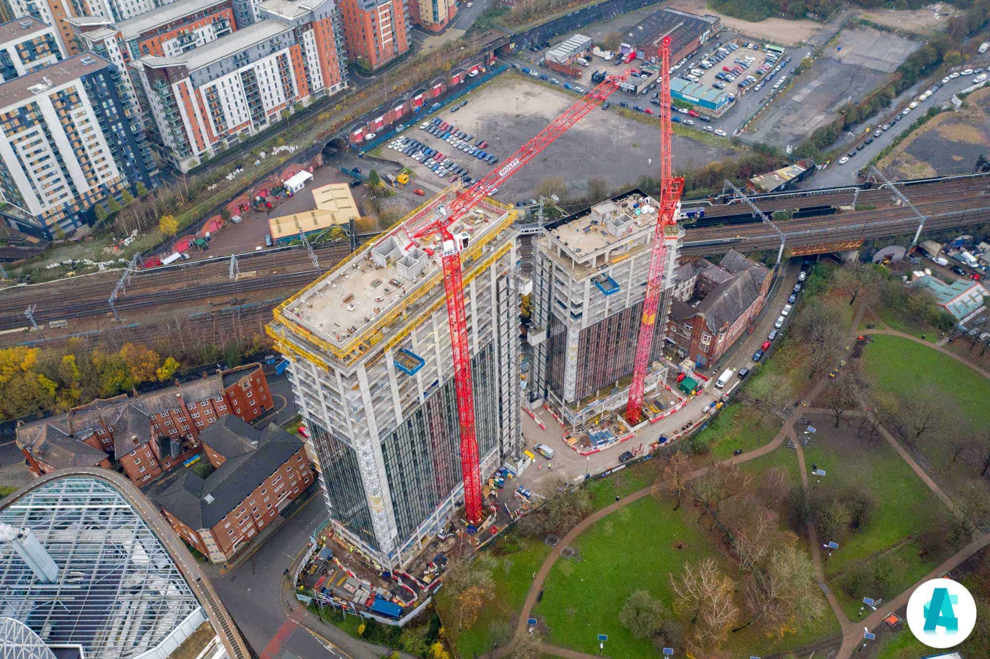 Aerial drone view of ongoing construction of tower blocks with cranes in Manchester UK Aerial Construction Services