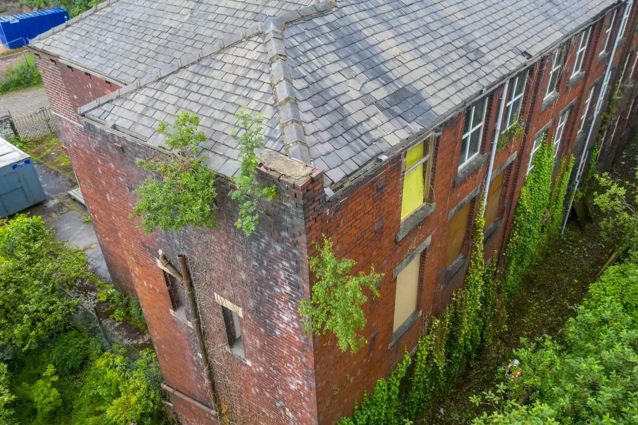 Aerial drone roof inspection on old broken building Lancashire