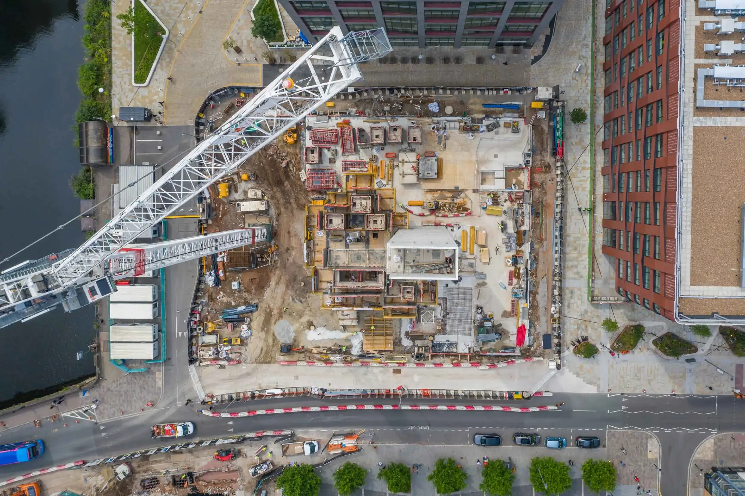 Aerial drone progress reporting of a construction project in Manchester City Centre during the early stages next to the river