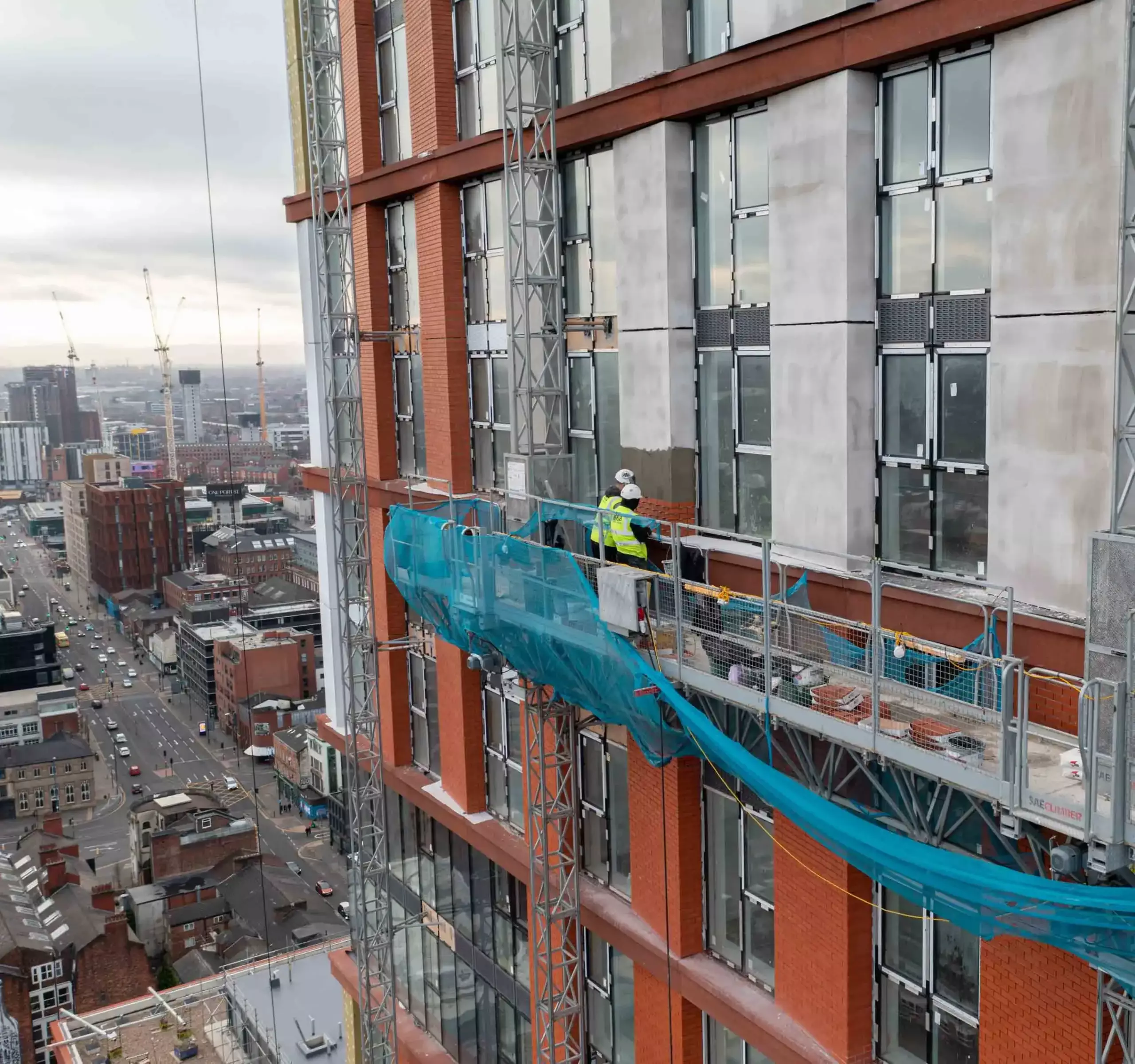 Aerial filming of workers on mast climber Manchester